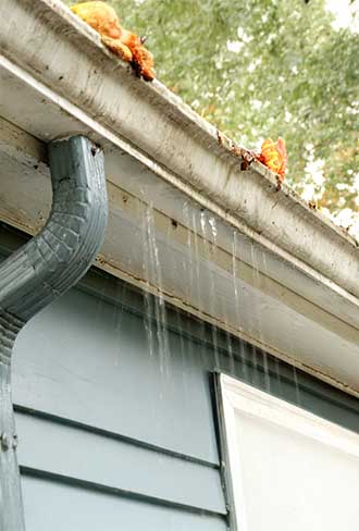 Clogged gutters being removed for replacement